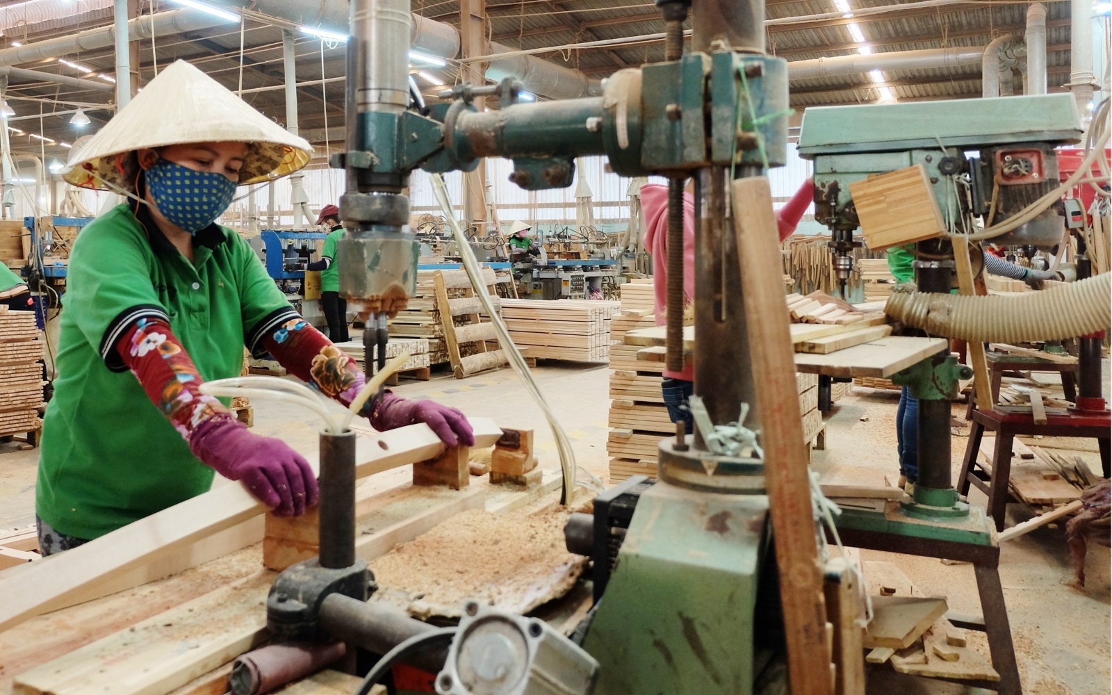 A worker is working with wood